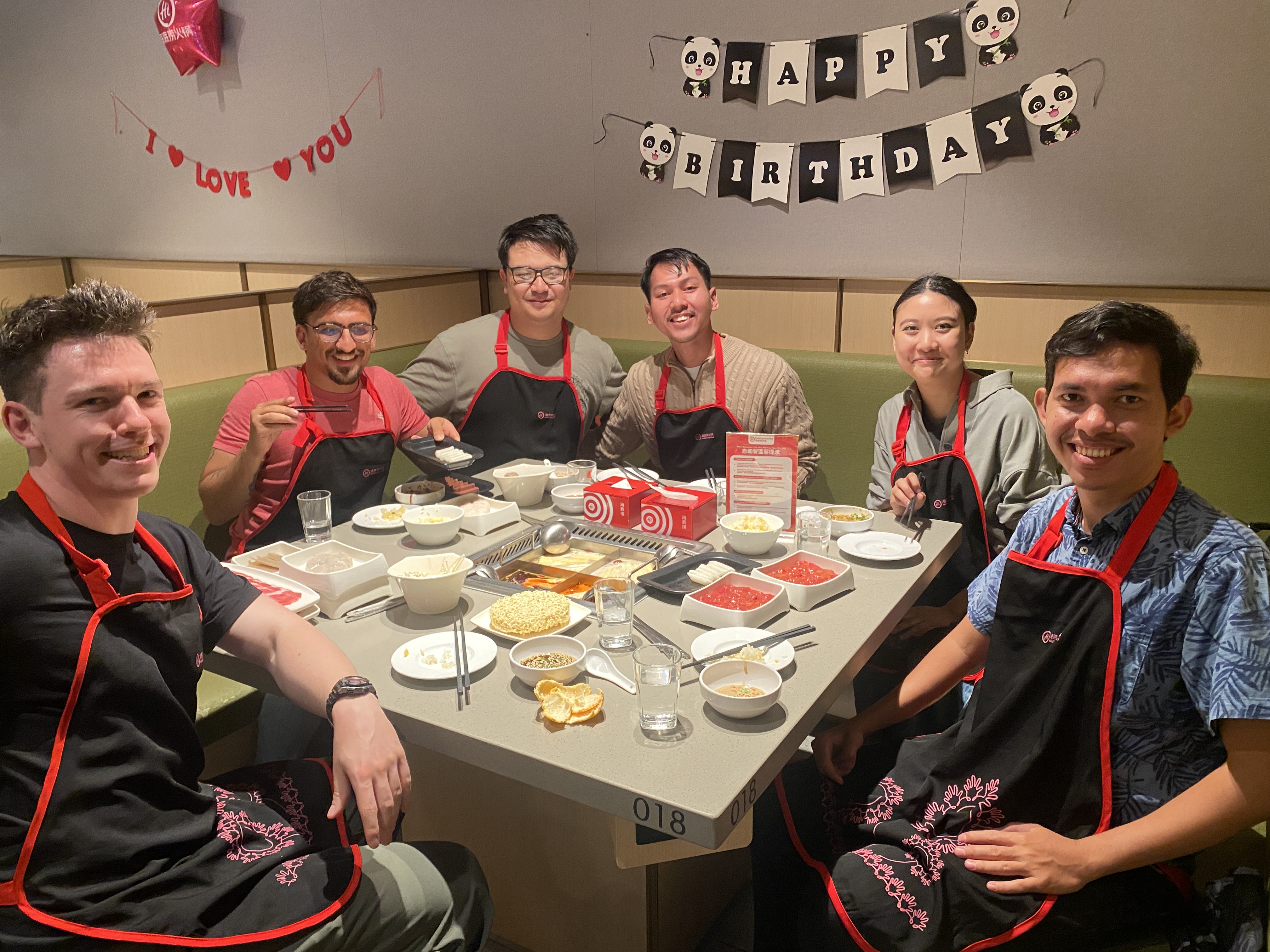 Ahmad Arib (right) with Tripledot Studios team members at a team dinner celebration